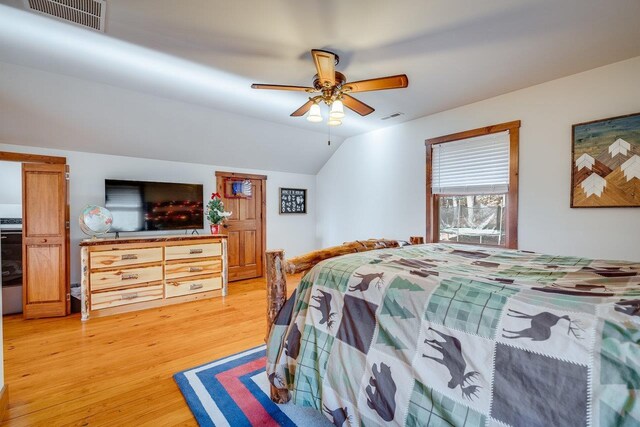 bedroom featuring hardwood / wood-style flooring, ceiling fan, and vaulted ceiling