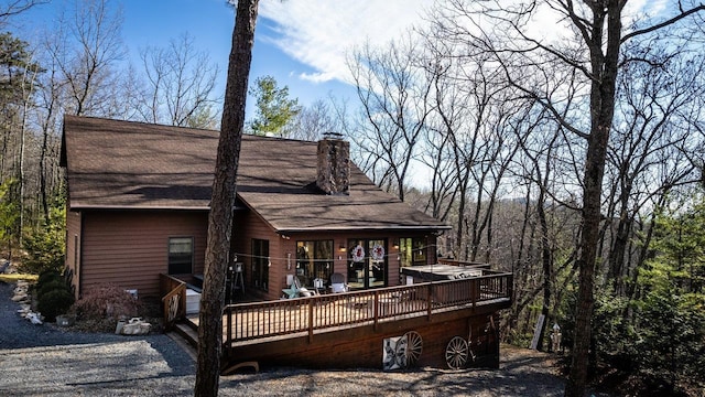 back of house featuring a deck