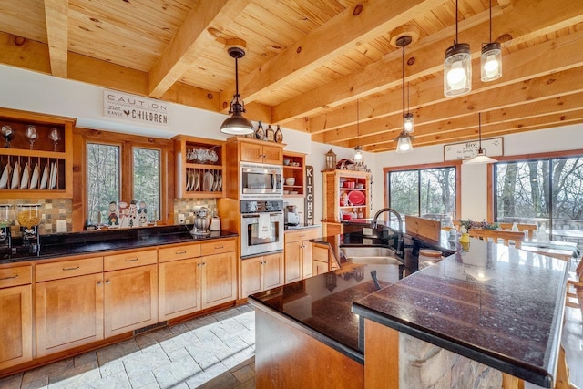 kitchen with a spacious island, sink, hanging light fixtures, wooden ceiling, and stainless steel appliances