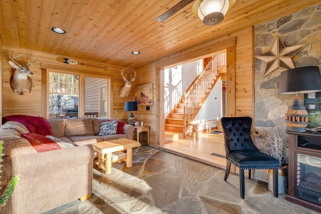 living room with wood ceiling and wood walls