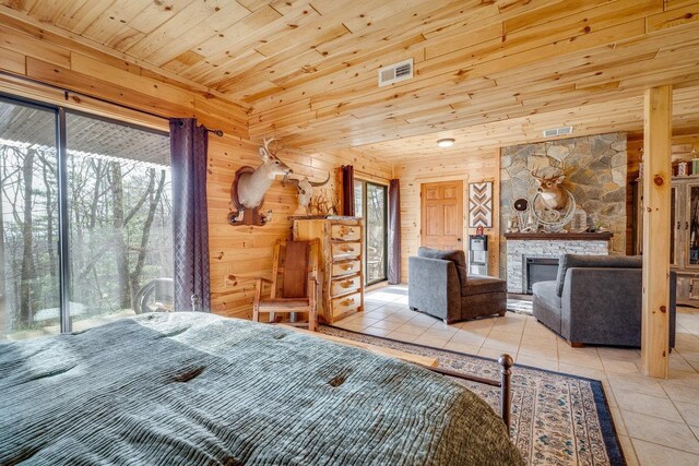 unfurnished bedroom featuring multiple windows, light tile patterned floors, and wood walls