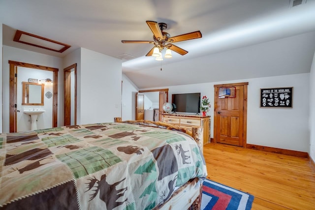 bedroom with lofted ceiling, hardwood / wood-style floors, ceiling fan, and ensuite bathroom