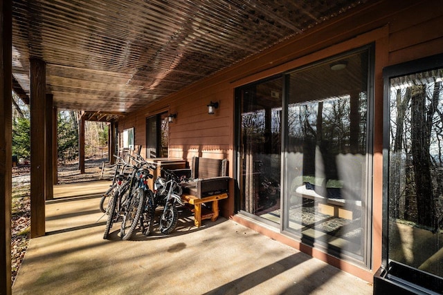 sunroom / solarium featuring wood ceiling