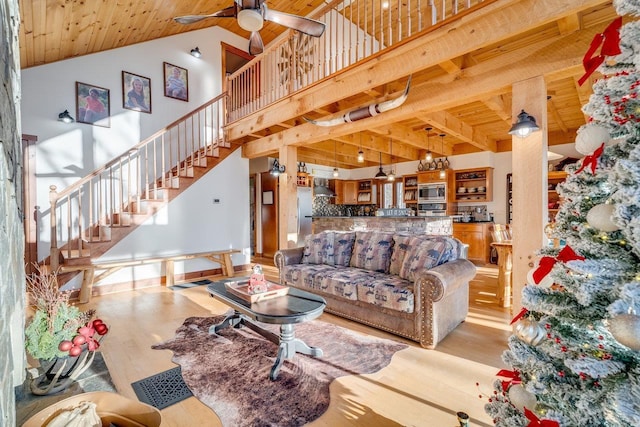 living room with high vaulted ceiling, wooden ceiling, ceiling fan, and light wood-type flooring