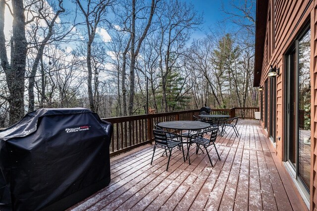 wooden terrace featuring a grill