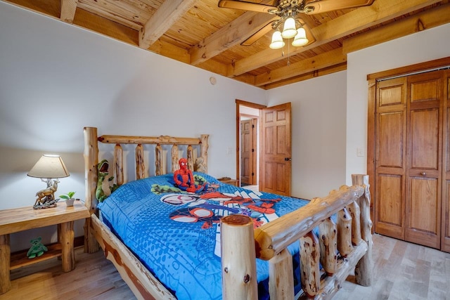 bedroom with beamed ceiling, ceiling fan, light hardwood / wood-style flooring, and wooden ceiling