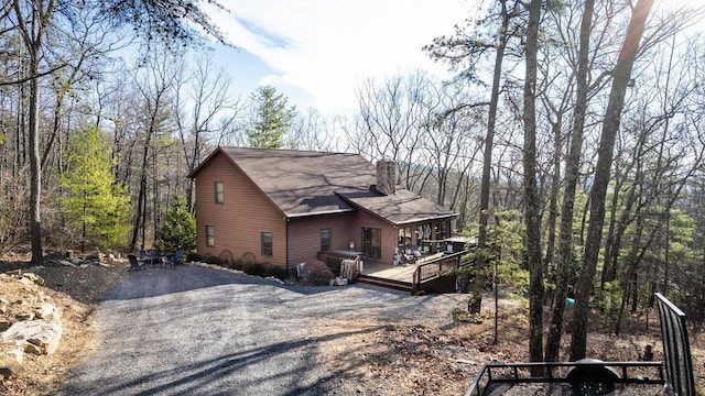 view of side of home with a wooden deck