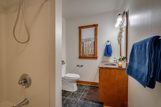 bathroom with vanity, tile patterned floors, toilet, and tiled shower