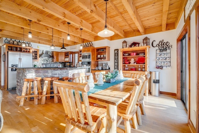 dining space featuring indoor bar, wooden ceiling, and light hardwood / wood-style flooring