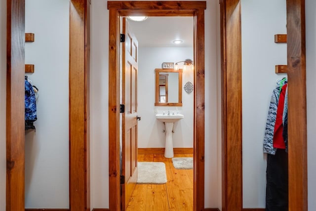 corridor with light hardwood / wood-style flooring