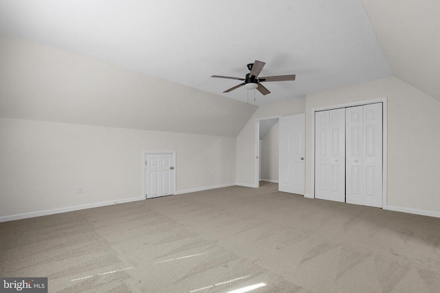 bonus room featuring lofted ceiling, carpet, baseboards, and ceiling fan