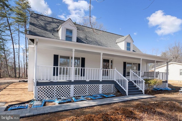 view of front of home featuring covered porch and a shingled roof