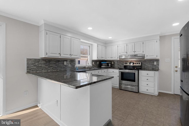 kitchen featuring a sink, dark stone counters, stainless steel electric range, a peninsula, and white cabinets