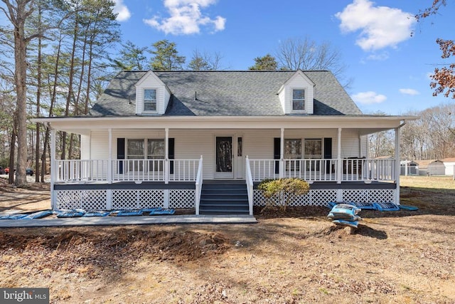 farmhouse inspired home with covered porch and a shingled roof