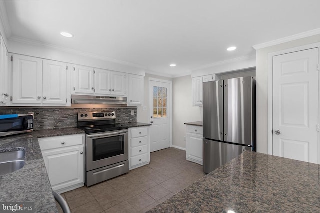 kitchen with under cabinet range hood, tasteful backsplash, appliances with stainless steel finishes, and white cabinetry