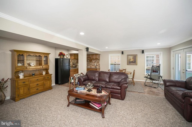 living area featuring ornamental molding, recessed lighting, french doors, baseboards, and light colored carpet