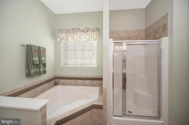 full bath featuring a shower stall and a bath