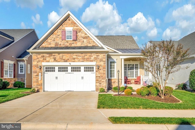 view of front facade featuring a front yard, driveway, a standing seam roof, covered porch, and a garage