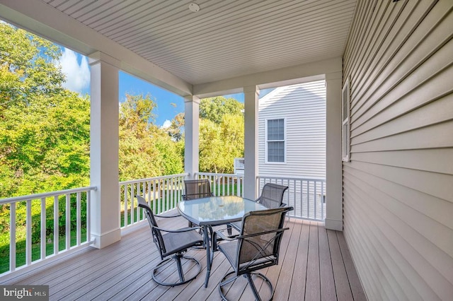 wooden deck featuring outdoor dining space