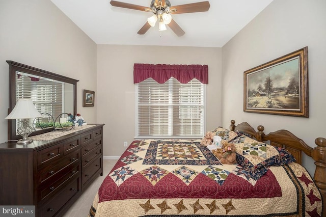 bedroom featuring baseboards, light colored carpet, and a ceiling fan