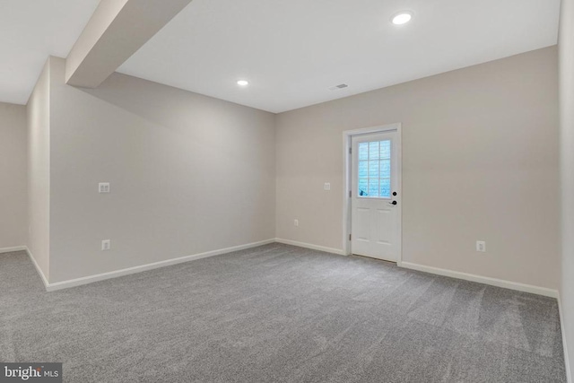 carpeted spare room featuring visible vents, baseboards, and recessed lighting