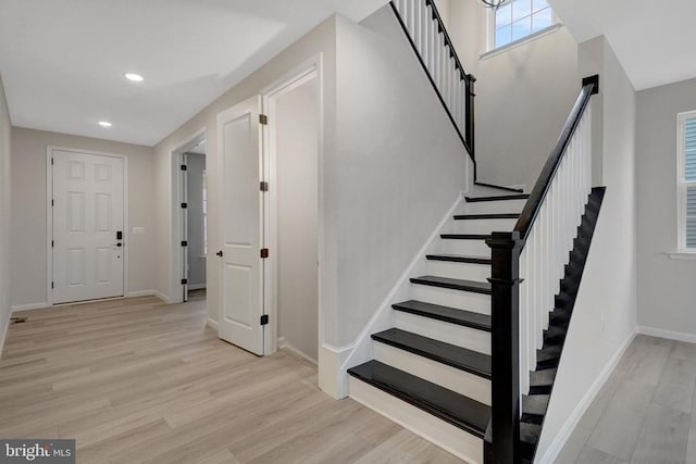 stairs featuring recessed lighting, wood finished floors, and baseboards