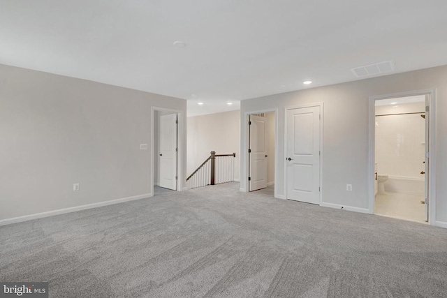 spare room with baseboards, recessed lighting, visible vents, and light colored carpet