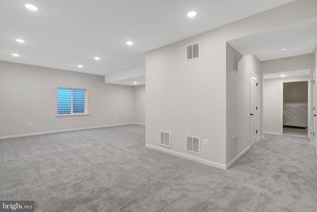 interior space featuring visible vents and light colored carpet