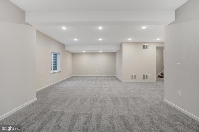 below grade area featuring stairway, baseboards, and visible vents