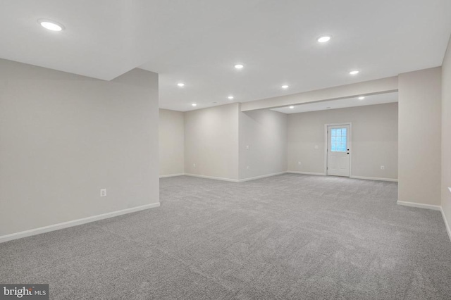 empty room featuring light carpet, baseboards, and recessed lighting