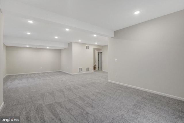 finished basement with baseboards, stairway, visible vents, and recessed lighting