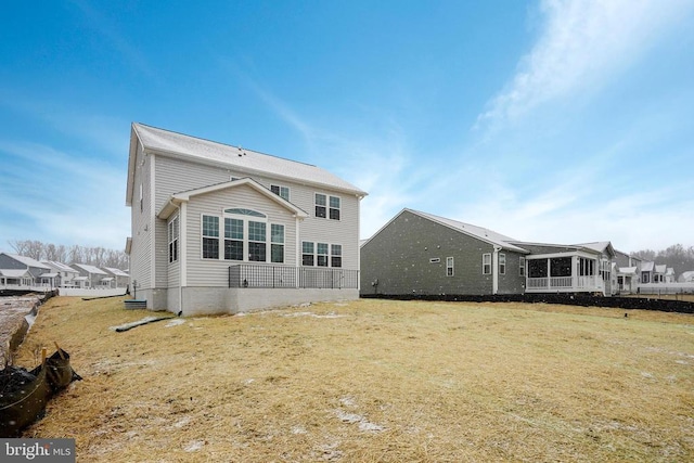 rear view of property with a lawn