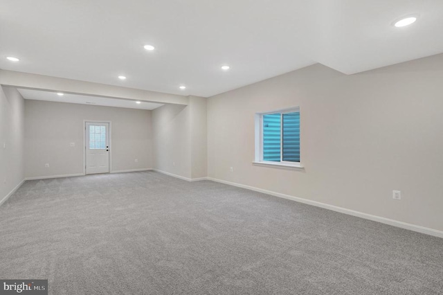 spare room featuring light carpet, baseboards, and recessed lighting