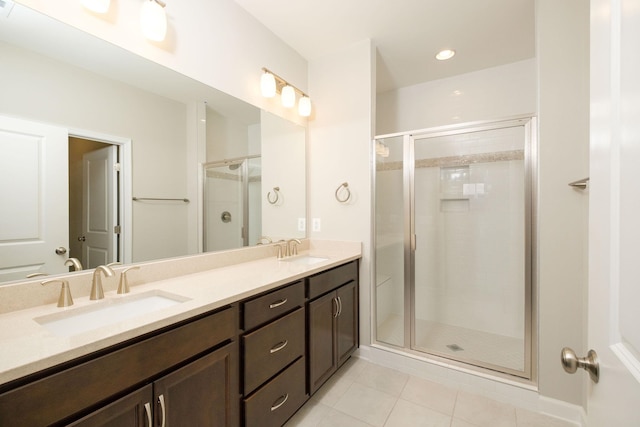 bathroom with an enclosed shower, vanity, and tile patterned floors