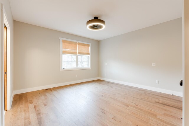 empty room with light hardwood / wood-style flooring