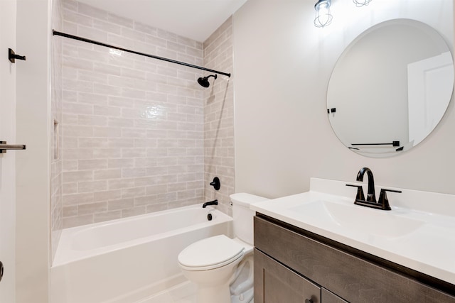 full bathroom featuring vanity, tiled shower / bath combo, and toilet