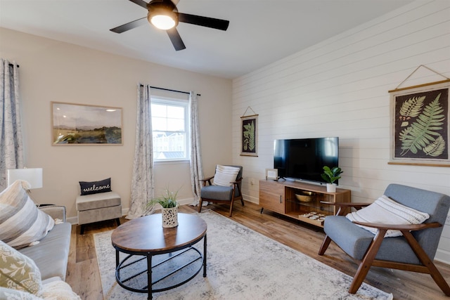 living room with ceiling fan and light wood-type flooring