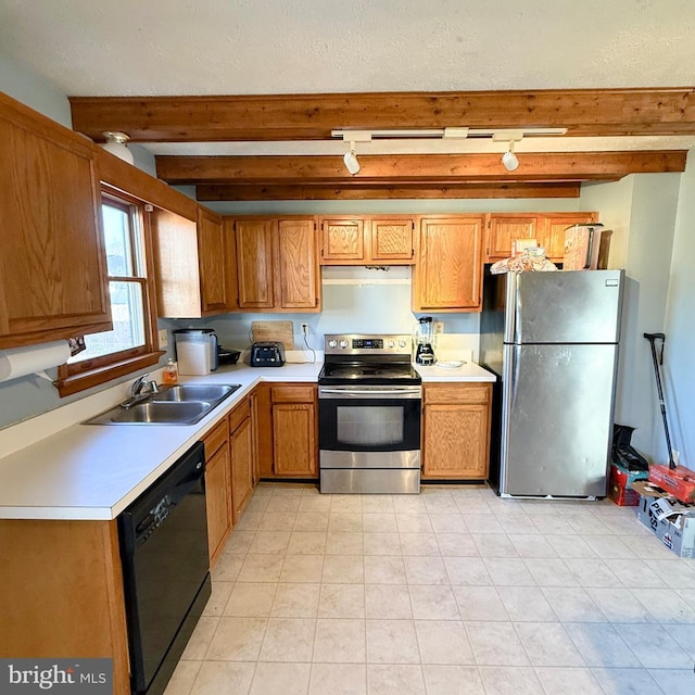 kitchen featuring stainless steel appliances, a sink, light countertops, beam ceiling, and brown cabinetry