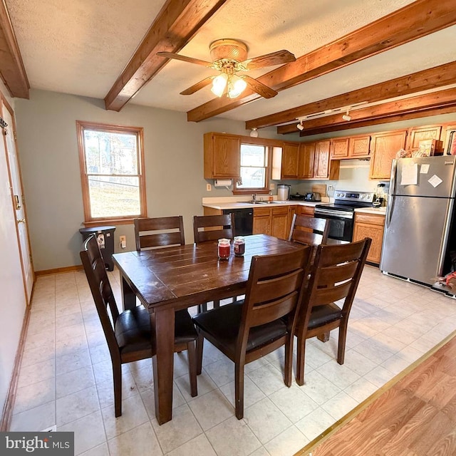 dining area featuring ceiling fan, a textured ceiling, baseboards, and beam ceiling