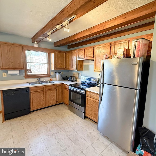 kitchen featuring stainless steel appliances, light countertops, a sink, a textured ceiling, and beamed ceiling