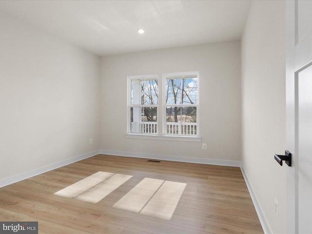 empty room featuring recessed lighting, visible vents, baseboards, and wood finished floors