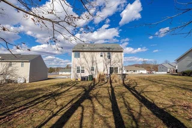 back of property featuring a residential view and a yard