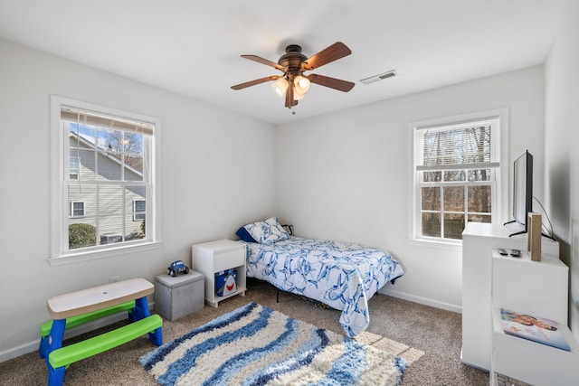 bedroom featuring carpet, visible vents, baseboards, and multiple windows