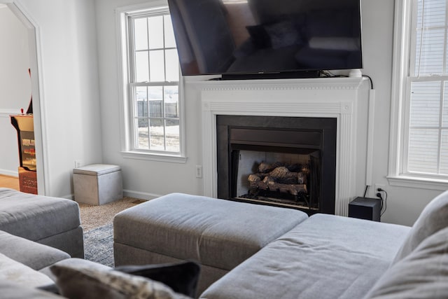 carpeted bedroom with a fireplace and baseboards