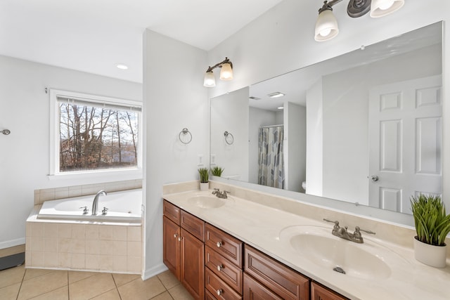 full bathroom with double vanity, a garden tub, a sink, and tile patterned floors