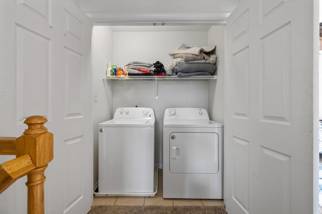 washroom with laundry area, separate washer and dryer, and light tile patterned flooring