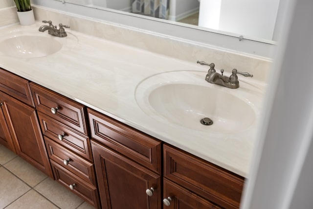 bathroom with double vanity, a sink, and tile patterned floors