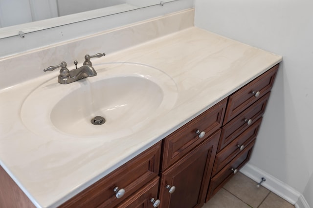 bathroom featuring tile patterned flooring, vanity, and baseboards