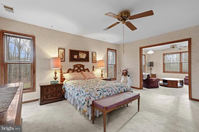 bedroom with light colored carpet and ceiling fan