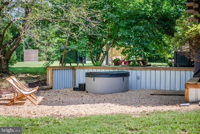 view of yard with central air condition unit and a hot tub